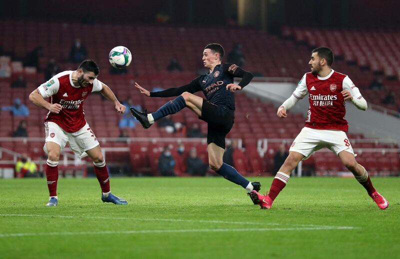 LONDON, ENGLAND - DECEMBER 22: Sead Kolasinac of Arsenal defends from Phil Foden of Manchester City  during the Carabao Cup Quarter Final match between Arsenal and Manchester City at Emirates Stadium on December 22, 2020 in London, England. The match will be played without fans, behind closed doors as a Covid-19 precaution. (Photo by Catherine Ivill/Getty Images)