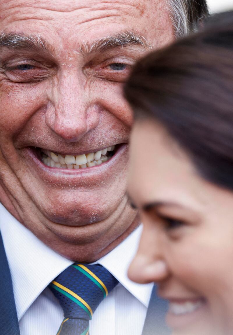 Brazil's President Jair Bolsonaro, who is in a run-off for re-election, and his wife Michelle Bolsonaro in a light-hearted moment at news conference with political supporters at Alvorada Palace in Brasilia. Reuters