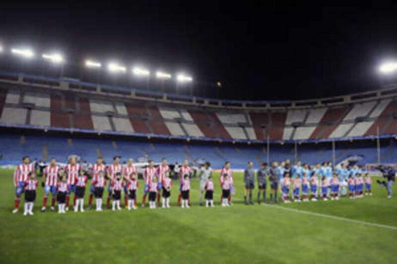 Atletico and PSV line up at an empty Vicente Calderon stadium in Madrid on Wednesday.