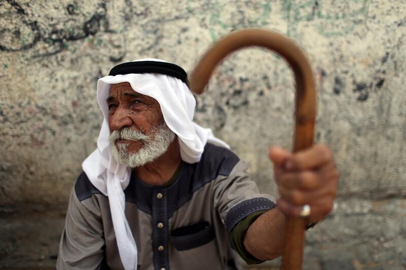 A Palestinian man sits outside his house in Khan Younis refugee camp in the southern Gaza Strip May 21, 2019. REUTERS/Ibraheem Abu Mustafa