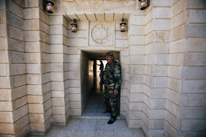 A Yazidi fighter stands at the entrance of Yazidi temple Sharaf Al Din, in Sinjar, Iraq.  Reuters