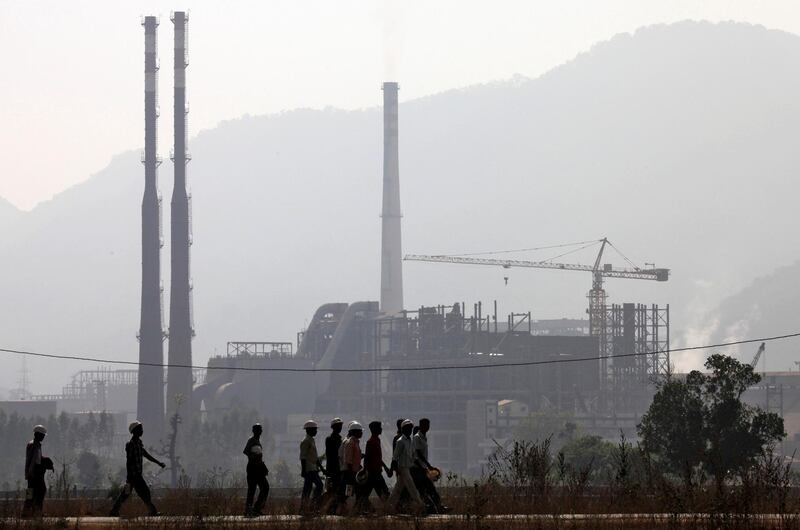 FILE PHOTO: Workers walk in front of the Vedanta Aluminium factory in Lanjigarh in Orissa state February 22, 2010. REUTERS/Reinhard Krause/File Photo                              GLOBAL BUSINESS WEEK AHEAD        SEARCH GLOBAL BUSINESS 29 JAN FOR ALL IMAGES