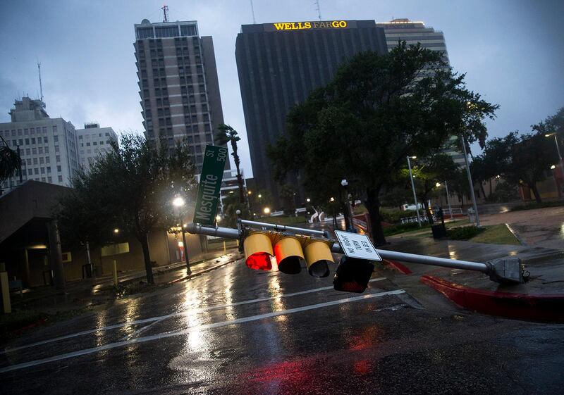 A damaged stop light blocks a street as Hurricane Harvey makes landfall in Corpus Christi, Texas. Nick Wagner / Austin American-Statesman via AP