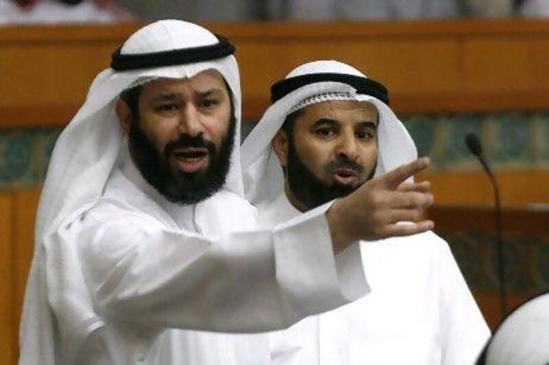 Kuwaiti MP Faisal Al Muslim, left, said the parliamentary panel has not accepted Sheikh Nasser's refusal to attend the hearing and a new summons has been issued for May 26.