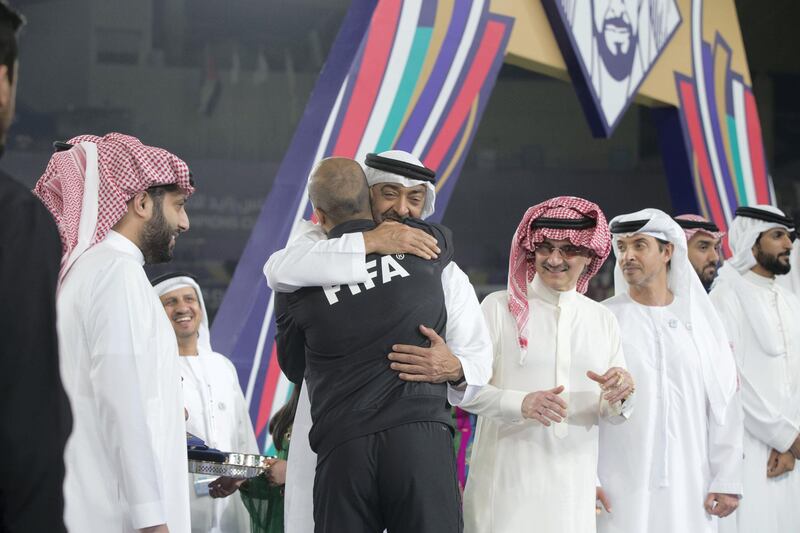 AL AIN, UNITED ARAB EMIRATES - April 18, 2019: HH Sheikh Mohamed bin Zayed Al Nahyan Crown Prince of Abu Dhabi Deputy Supreme Commander of the UAE Armed Forces (3rd L) greets a referee after Etoile du Sahel won the 2018–19 Zayed Champions Cup, at Hazza bin Zayed Stadium. Seen with HH Sheikh Hazza bin Zayed Al Nahyan, Vice Chairman of the Abu Dhabi Executive Council (3rd R), HRH Prince Alwaleed bin Talal bin Abdulaziz Al Saud (4th R) and HE Turki bin Abdul Mohsen Al Sheikh, Chairman of the General Entertainment Authority of Saudi Arabia (L).

( Mohammed Al Bloushi for Ministry of Presidential Affairs )
---