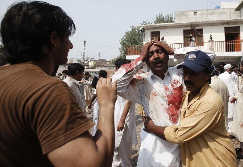 A man cries at the death of his brother at the site of a suicide blast at a church in Peshawar. REUTERS/Fayaz Aziz

