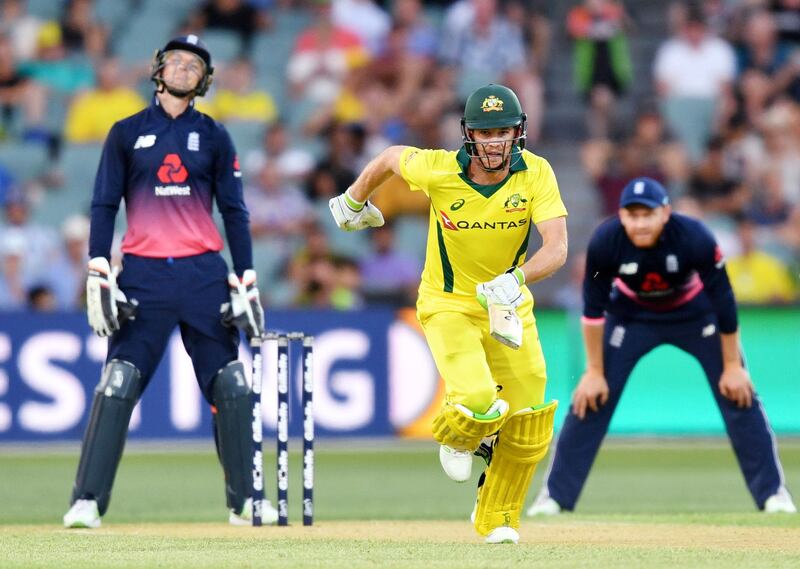 Australia's Tim Paine, center, makes runs against England during their one day international cricket match in Adelaide, Friday, Jan. 26, 2018. (David Mariuz/AAP via AP)