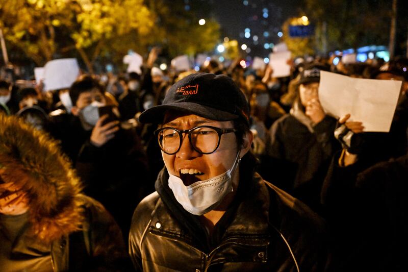 Demonstrators rally in Beijing. China reported more than 40,000 new cases of Covid-19 on Monday. AFP