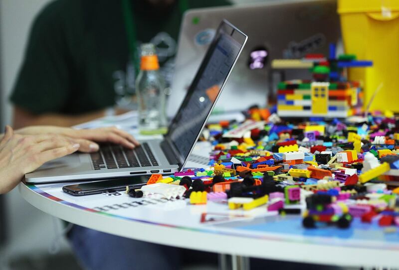 Attendees use laptop computers as Lego A/S toybricks sit on a desk in the Hackathon area at the Bosch Internet of Things (IoT) conference, in Berlin, Germany, on Wednesday, Feb. 21, 2018. Bosch raked in record profit and revenue last year and foresees more growth in 2018 even as the German auto-parts giant wrestles with weakness in the scandal-beset diesel segment that might be compounded by controversial air-quality tests on monkeys. Photographer: Krisztian Bocsi/Bloomberg