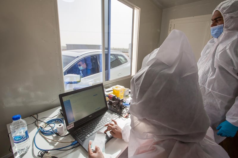 Dubai, United Arab Emirates - Medical staff processing the test at the new DPI Testing Centres border of Dubai and Abu Dhabi.  Leslie Pableo for The National for Shireena Al Nowais story