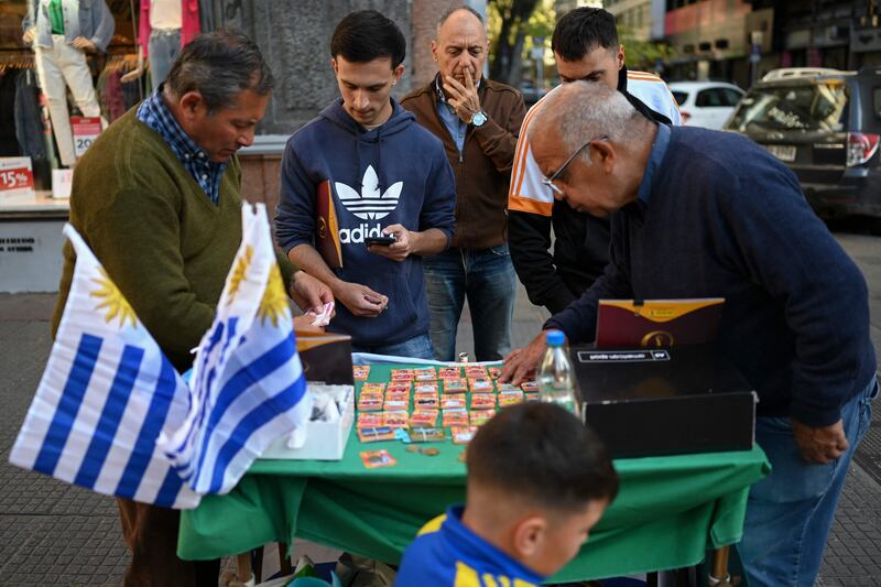 The Panini World Cup football stickers fever is felt the world over. A man pictured in downtown Montevideo, Uruguay, selling and exchanging stickers.  AFP