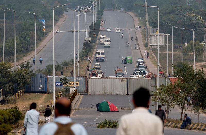 Authorities place shipping containers to stop protesters at an entrance to the capital center following a court decision in favor of a Christian woman in Islamabad, Pakistan. Christian woman Asia Bibi acquitted in Pakistan after eight years on death row for blasphemy plans to leave the country, her family said Thursday as radical Islamists mounted rallies for a second day against the verdict, blocking roads and burning tires in protest. AP Photo