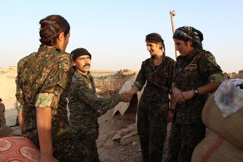 Gender equality on the Kurdish frontlines in Syria is real, as men and women in combat fatigues sit together chatting and sharing jokes.