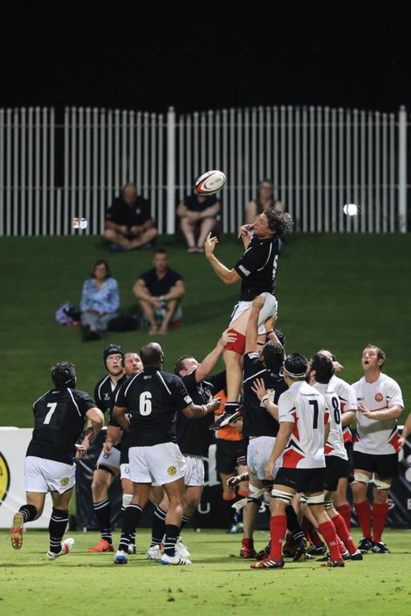UAE rugby player Adam Telford catches the ball from a line-out during their Test match against Singapore on Wednesday. Sarah Dea / The National / April 23, 2014