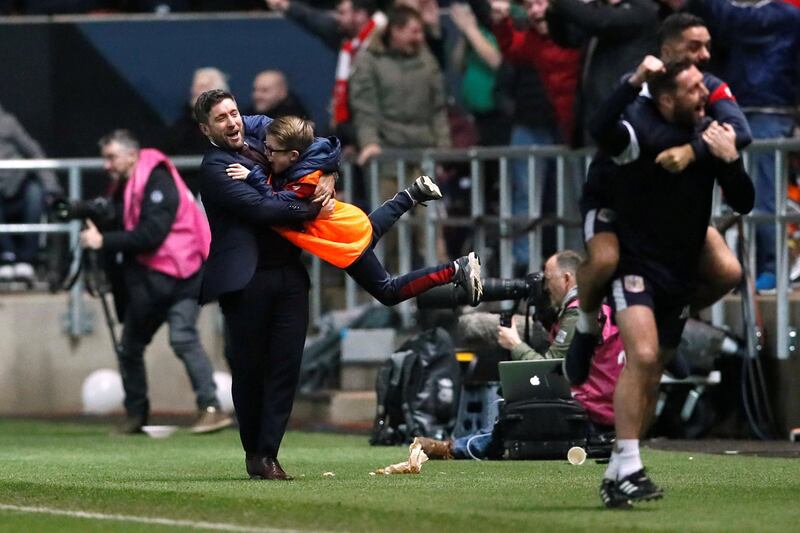 Bristol City manager Lee Johnson celebrates with a ball boy. David Klein / Reuters