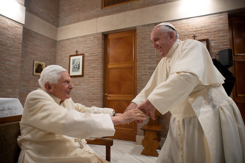 Pope Francis greets Pope Emeritus Benedict XVI during a meeting following a consistory ceremony to install 13 new cardinals, at the Vatican, November 28, 2020. Vatican Media/Handout via REUTERS    ATTENTION EDITORS - THIS IMAGE WAS PROVIDED BY A THIRD PARTY.     TPX IMAGES OF THE DAY