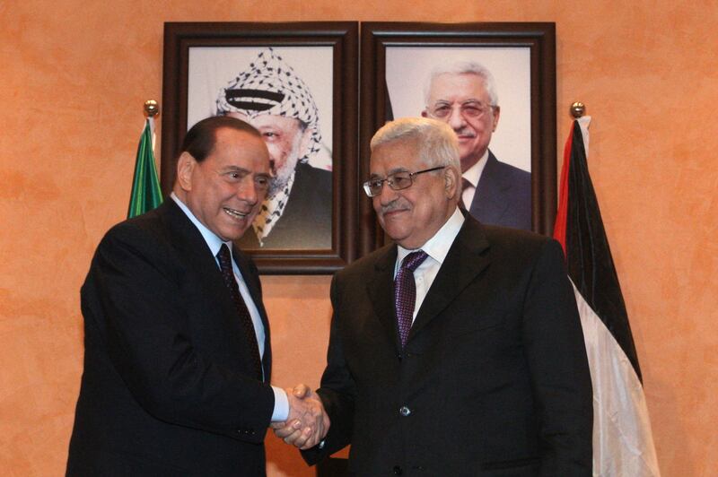 Mr Berlusconi, left, shakes hands with Palestinian President Mahmud Abbas in Bethlehem in February 2010.  AFP 