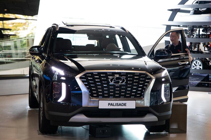 A customer looks at a Hyundai Motor Co. Palisade sport utility vehicle (SUV) on display at the company's Motorstudio showroom in Goyang, South Korea, on Friday, July 19, 2019. Hyundai is scheduled to release second-quarter earnings result on July 22. Photographer: SeongJoon Cho/Bloomberg
