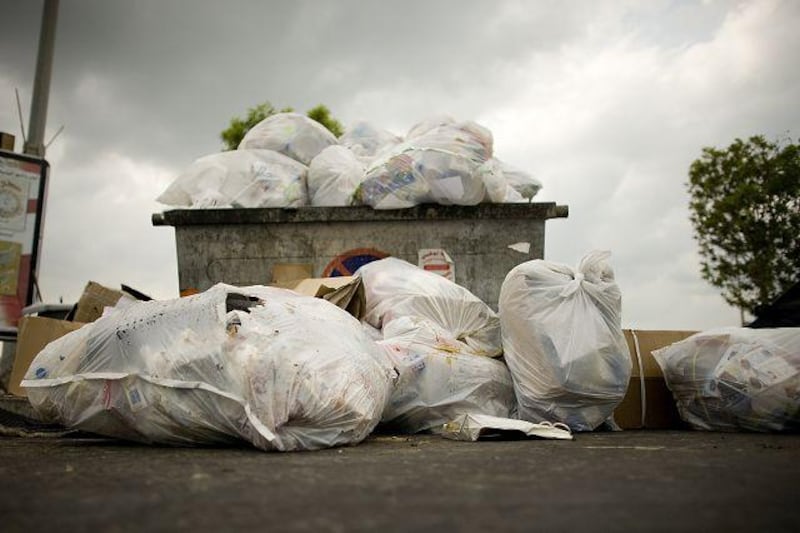 A dumpster at a UAE overflows with rubbish.