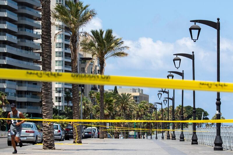 A man jogs near a cordoned off area which is almost empty of residents and tourists, officially closed following the government's measures to help stop the spread of the coronavirus, in Beirut, Lebanon. AP Photo