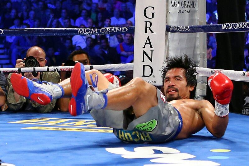 LAS VEGAS, NV - DECEMBER 08: Manny Pacquiao is knocked down in the third round while taking on Juan Manuel Marquez during their welterweight bout at the MGM Grand Garden Arena on December 8, 2012 in Las Vegas, Nevada.   Al Bello/Getty Images/AFP== FOR NEWSPAPERS, INTERNET, TELCOS & TELEVISION USE ONLY ==
 *** Local Caption ***  064424-01-09.jpg