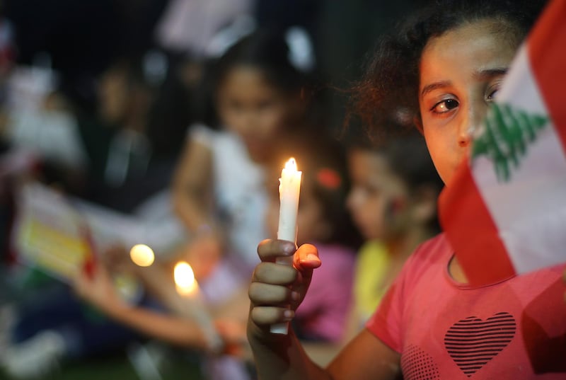 Palestinians light candles to show solidarity with the Lebanese people following Tuesday's blast in Beirut's port area, in Rafah in the southern Gaza Strip. REUTERS