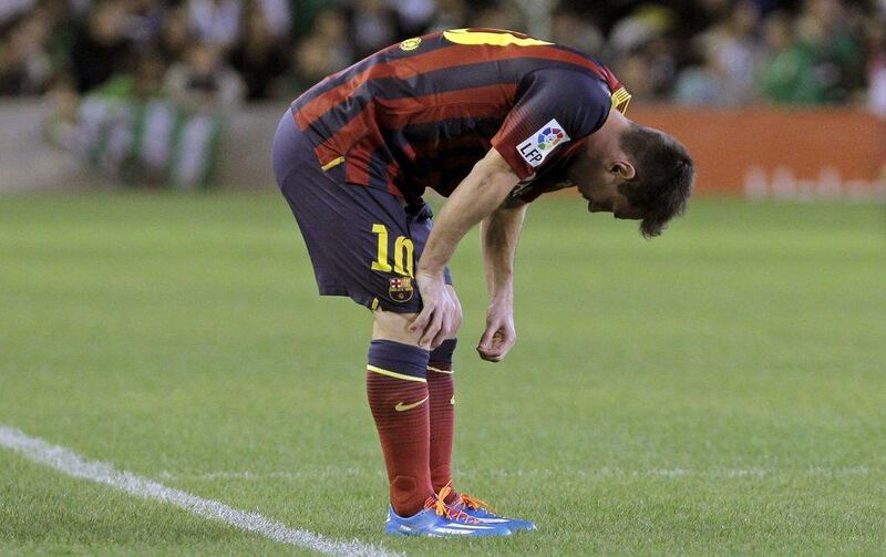 Lionel Messi had to leave Barcelona's 4-1 win over Real Betis on Sunday after injuring his left hamstring. Julio Munoz / EPA