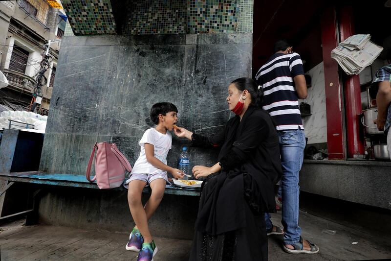 An Indian family eats lunch at a street food stall in Kolkata, Eastern India, October 9.  Piyal Adhikary / EPA