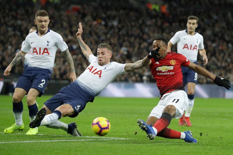 Tottenham's Toby Alderweireld dives to stop a shot on goal by Manchester United's Anthony Martial, right. AP Photo