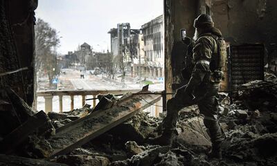 A Russian soldier patrols at the Mariupol drama theatre. AFP