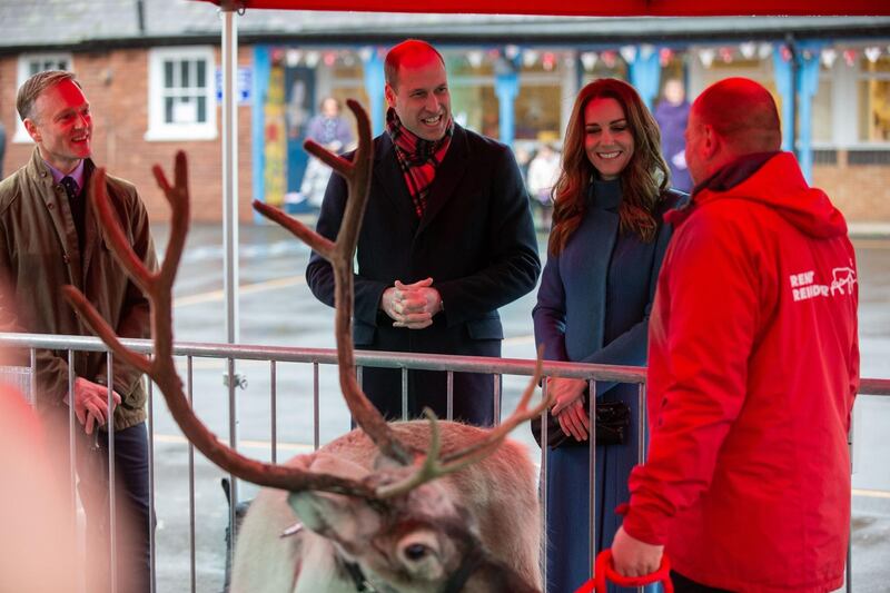 Prince William, and Catherine, Duchess of Cambridge chat with a reindeer handler during a visit to the Holy Trinity Church of England First School in Berwick-Upon-Tweed, north-east England. AFP