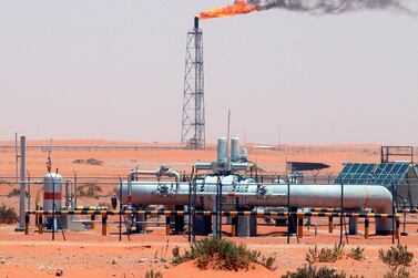 A gas flame behind pipelines in the desert at Khurais oil field, about 160 km from Riyadh. EPA