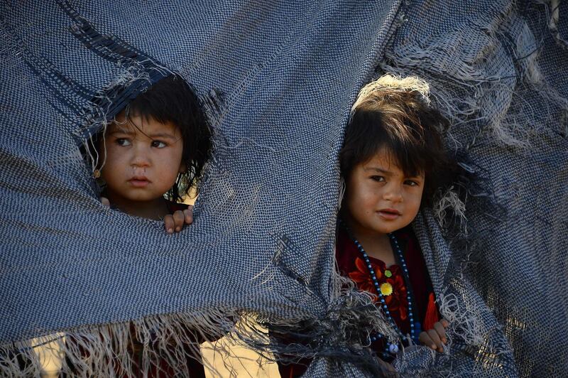 Children look on from their tent at a camp in Injil district of Herat, Afghanistan. AFP