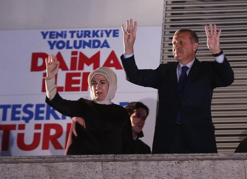 Turkish Prime Minister Recep Tayyip Erdogan, right, and his wife Emine greet the crowd from the balcony of the Justice and Development Party headquarters in Ankara. (Adem Altan / AFP Photo / March 31, 2014)