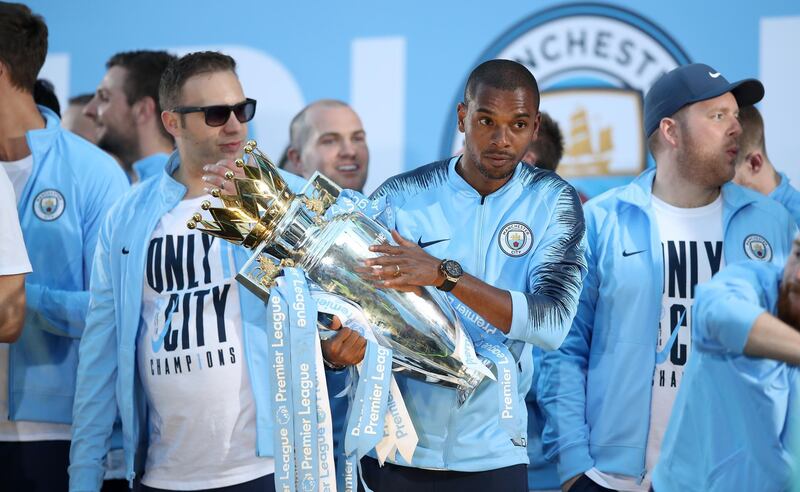 Fernandinho of Manchester City holds the trophy during the Manchester City trophy parade. Lynne Cameron / Getty Images