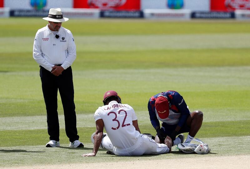 West Indies batsman John Campbell receives treatment after being hit on the toe. Reuters