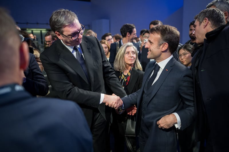 France's President Macron (right) shakes hand with Serbia's President Aleksandar Vucic after his speech. AFP