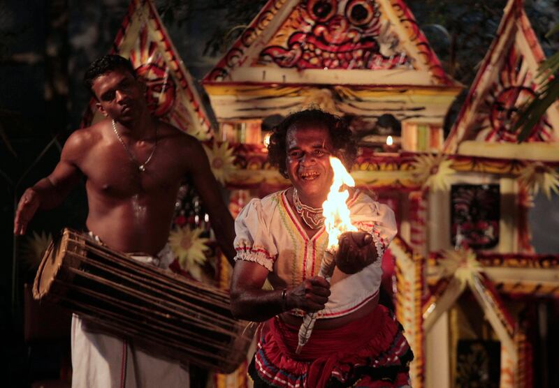 In this Saturday, Dec. 31, 2011 photo, Sri Lankan folk dancers perform a ritual on the eve of New Year in Colombo, Sri Lanka. The ritual is aimed to bless the country in the new year and to ward off the bad spirits .(AP Photo/ Eranga Jayawardena) *** Local Caption ***  Sri Lanka New Year .JPEG-0f28f.jpg