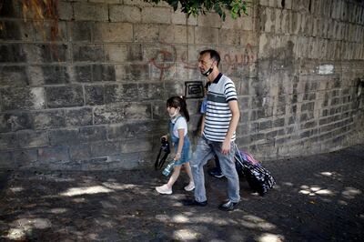A man with his children at the end of their school day in Beirut, in 2021. AP