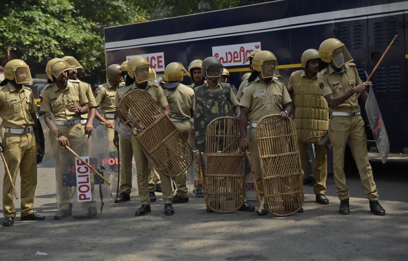 Policemen take position outside the state secretariat anticipating protests following reports of two women of menstruating age entering the Sabarimala temple, one of the world's largest Hindu pilgrimage sites, in Thiruvananthapuram, Kerala, India, Wednesday, Jan. 2, 2019. India's Supreme Court on Sept. 28, 2018 lifted the ban on women of menstruating age from entering the temple, holding that equality is supreme irrespective of age and gender. (AP Photo/R S Iyer)
