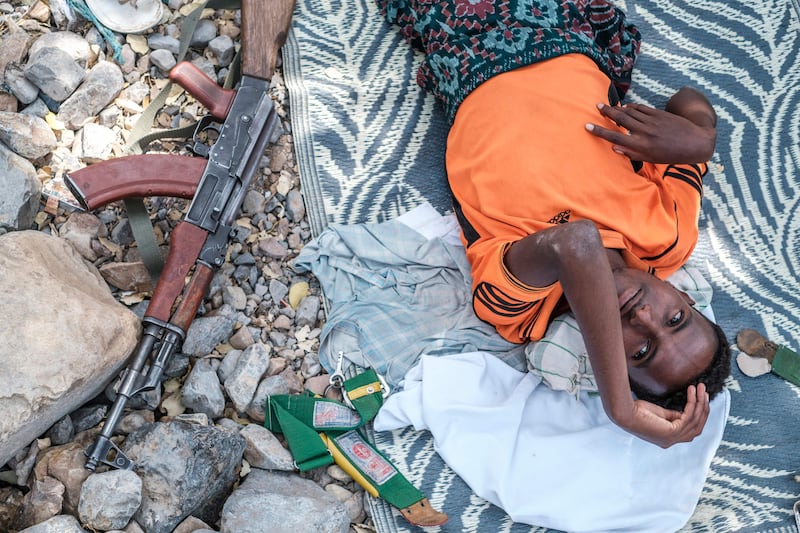 A member of the Afar militia takes a rest next to his weapon in the makeshift camp. AFP