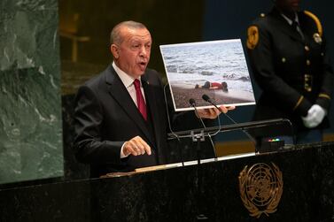 Recep Tayyip Erdogan, Turkey's president, holds up a photograph of deceased Syrian refugee Alan Kurdi while speaking during the UN General Assembly meeting in New York. Bloomberg