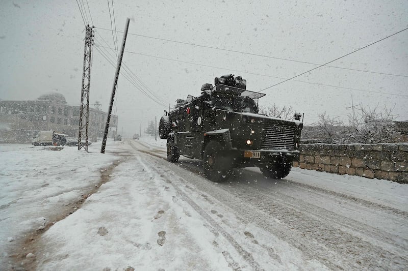 A Turkish military vehicle advances along a snow-covered road in the Jabal Al Zawiyah area of north-west Syria. AFP