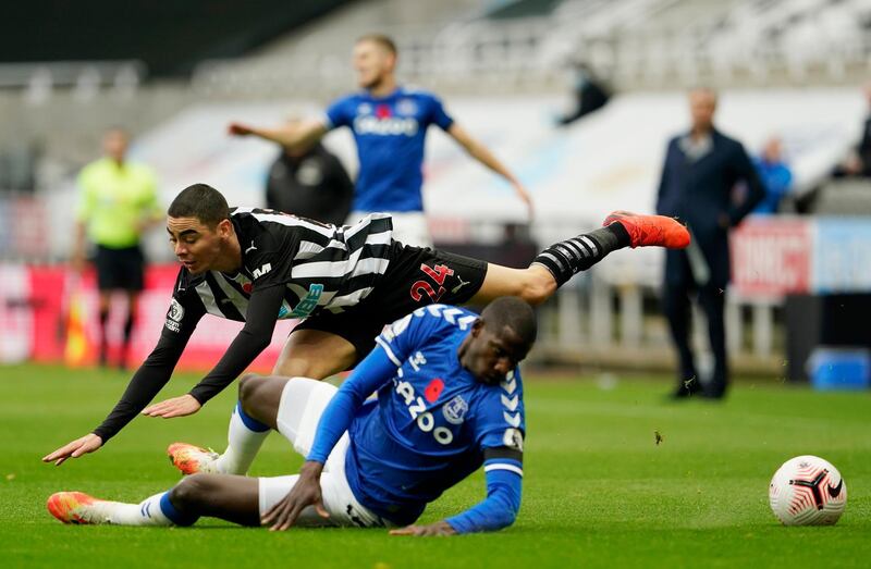 Newcastle's Miguel Almiron is challenged by Everton midfielder Abdoulaye Doucoure. Reuters