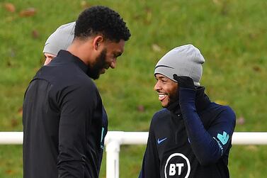 Defender Joe Gomez (L) and England's midfielder Raheem Sterling appear relaxed at England's team training session at St George's Park on Tuesday. AFP