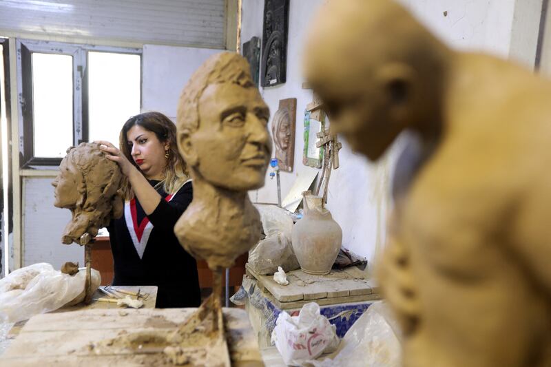 Karmal Mahmood Ali, who teaches sculpture at the College of Fine Arts in Baghdad, takes a class in the Iraqi capital. All photos by Reuters