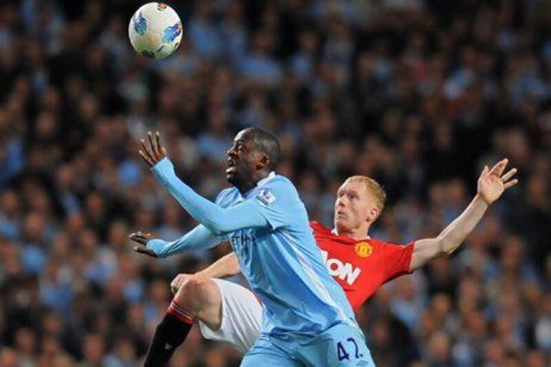 Yaya Toure, front, and Paul Scholes tussle for the ball during the corresponding Premier League fixture at Etihad Stadium last season. Andrew Yates / AFP