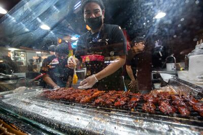 Chicken barbecue skewers at the Floating Market in Global Village is a Filipino favorite. Ruel Pableo for The National