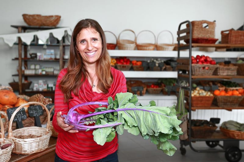 Elena Kinane, managing director of Greenheart Organic Farm Store, proudly shows off her organic, UAE grown,  'Blue Azure' heirloom Kohlrabi.   Victor Besa for The National