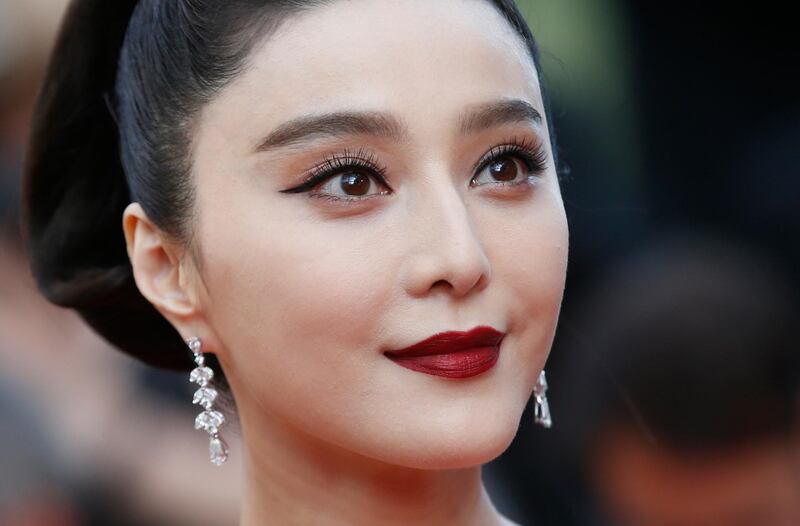 FILE - In this May 24, 2017, file photo, Fan Bingbing poses for photographers as she arrives for the screening of the film The Beguiled at the 70th international film festival, Cannes, southern France. Chinese media said on Wednesday, Oct. 3, 2018, tax authorities ordered X-Men star Fan to pay taxes and fines worth hundreds of millions of yuan but would spare her from criminal prosecution. (AP Photo/Alastair Grant, File)
